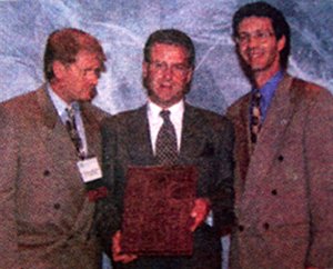 Dr. Greg Dunn receives an award. - Copyright – Stock Photo / Register Mark