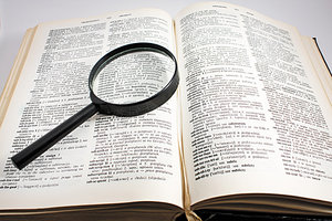 book and magnifying glass - Copyright – Stock Photo / Register Mark